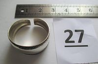 Sterling silver cuff bracelet shown from a top view with a ruler for size reference and a lot number card.