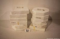 Photo showing styrofoam packaging boxes for the twelve plates stacked in two columns, suggesting original protective packaging for collector plates.