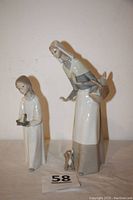 Both porcelain figurines together showing size and scale.