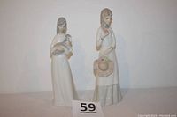 Front view of both porcelain figurines: lady with hat holding a rose and girl holding a lamb.