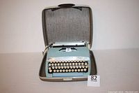 Open Sears Tower Citation 88 typewriter in light blue color inside its case, showing keyboard and carriage