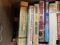 Photo showing books by Kurt Vonnegut, Hemingway, Bull Cosby, Caldwell, and Dostoevsky in a box.