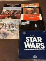 Full view of the collection of classic albums and soundtracks vinyl records showing cover art for Sesame Street Fever, My Fair Lady, West Side Story, The Empire Strikes Back, and Star Wars performed by The Electric Moog Orchestra among others.