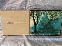 Beige textured slipcase with gold and black text 'Canada A Year of the Land'.