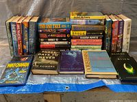 Overview of various science-fiction books and a DVD showing titles and condition