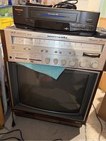 Panasonic VCR on top, stereo receiver in middle, Zenith CRT TV at bottom