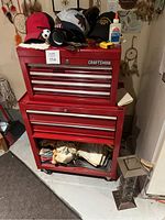 Full view of red Craftsman tool chest with items on top