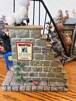 Figurine showing cats on stairs with 'Cats Rule!' text and a 'Wanted' poster for a robbery.