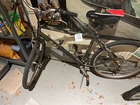 Black Raleigh men's multi-speed bicycle showing frame, wheels, seat, and handlebar.