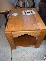 Pair of side tables shown from an angle displaying grain and stepped apron detail