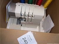 Singer ProFinish serger in open box with four thread cones