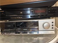 Photo of Teac PD-H40 CD Player and Aiwa SX-8500 Stereo Receiver stacked together. CD player is black, receiver is silver with multiple buttons and dial. Shows condition and front details.