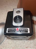 Close-up front view of Kodak Brownie Hawkeye Camera Flash model showing Kodak logo and lens.