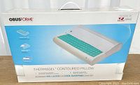 White box packaging of ObusForme Thermagel contoured memory foam pillow showing product image, key features like advanced gel layer for cooling and adjustable contour.