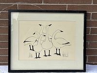 Framed artwork showing six snow geese in black ink on cream paper with a white mat and black frame.