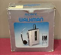 Original silver cardboard retail box with Sony Walkman WM-F1 graphics