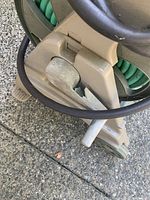 Close-up image of the cracked handle on the hose reel.
