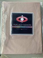 Front view of the sheet package showing Cuddle Down logo and Percale Fashion branding.