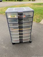 Front view of The Container Store rollable drawers unit with multiple drawers containing assorted items.