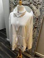 White Calvin Klein fishnet zip-up sport jacket on mannequin