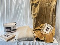 Photo showing the overall lot with packaged duvet cover and curtains along with blanket and curtain panels draped for display.