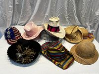 Eight assorted vintage sun hats including embellished sequin baseball cap, pink floppy hat, feather decorated black hat, striped fabric hat, and natural woven straw hats in boater and Panama styles.