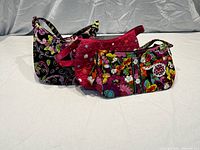 Three Vera Bradley bags in Va Va Bloom pattern arranged in a row showing size difference and designs