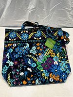 Front view of large Vera Bradley quilted purse with vibrant blue floral pattern and dual handles, displayed on white background.