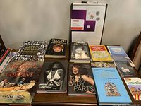 Books laid out on a wooden table showing titles and covers clearly for identification.