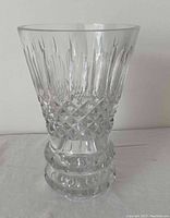 Clear decorative glass vase with intricate cut patterns and solid base