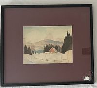 Framed watercolor of winter cottage in burgundy mat and black frame