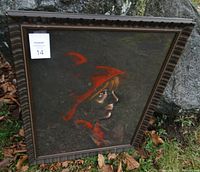 Frontal view of framed pastel painting showing a side profile of a crying girl wearing a red hood against a dark background.