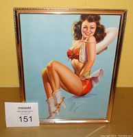 Front view of framed lithograph print showing pin-up girl in red with white boots on light blue background, signed by Billy DeVorss.