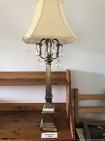 Tall decorative metal table lamp with beige fabric shade and marble base