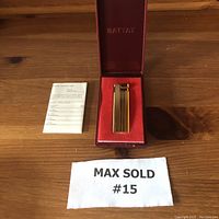 Gold tone vintage Battat lighter in hard plastic case with red velvet lining and instruction card.