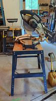 Side view of Mastercraft 10 inch compound mitre saw mounted on metal table stand in workshop.