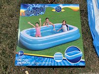 Photo of original box showing three-ring blue inflatable pool with children illustration