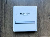 White retail box for MacBook Air SuperDrive showing the front with product name and optical drive image.