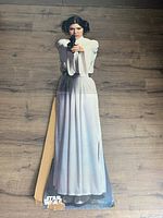 Full view of the life-size Princess Leia cardboard cutout laid flat showing water damage and bending.