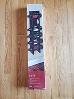 Photo of unopened box showing Santé wall mount wine rack with 12 bottle capacity and vertical design.