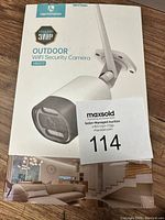 Front of the box showing the HeimVision HM311 3MP Outdoor WiFi Security Camera with floodlights depiction and branding.