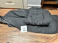 Grey Lauren Ralph Lauren men's suit jacket and trousers laid on wooden floor, showing overall suit with wear.