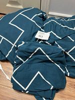 Photo of folded blue and white geometric patterned cover with lot tag 93