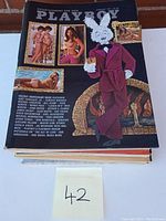 Top view of the stack of nine vintage Playboy magazines showing cover of 1970s issue