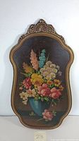 Full view of the floral bouquet oil painting in decorative frame.