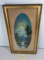 Framed pastel drawing showing full view with gold frame and beige matte board, oval window displaying landscape image.