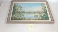 Full view of the framed watercolor landscape painting showing the scenery with houses along the water and tree foliage.