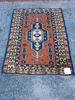 Full view of Kazak hand-woven rug showing overall design and colors