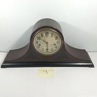 Front view of the vintage New Haven mantle clock showing wooden case and dial.