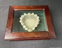 Top view of the wooden box with glass lid showing the Belleek heart-shaped dish inside.